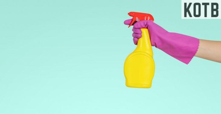 person holding yellow plastic spray bottle
