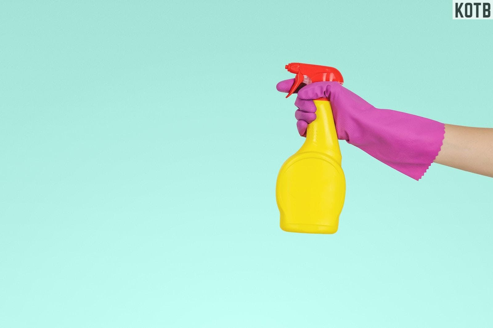 person holding yellow plastic spray bottle
