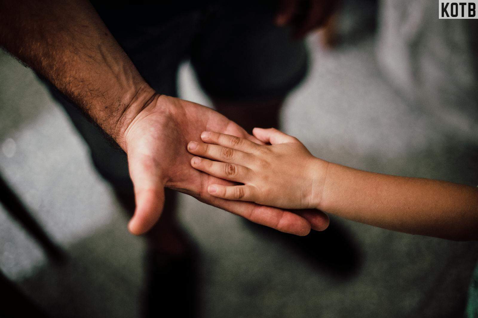 Father and Child's Hands Together