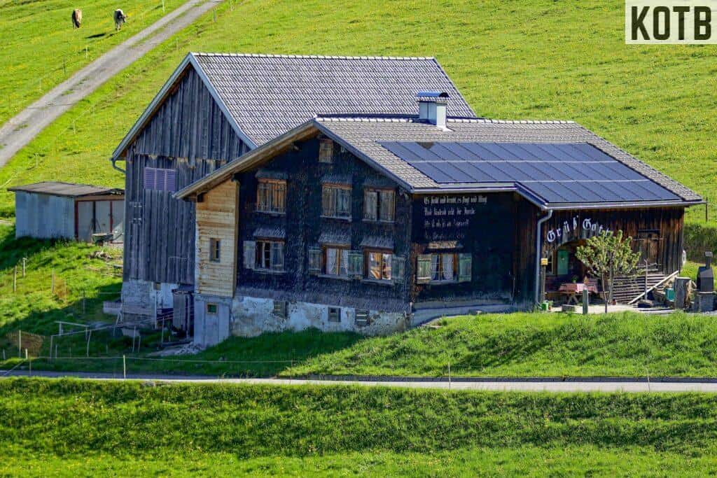 gray and black wooden house at middle of field