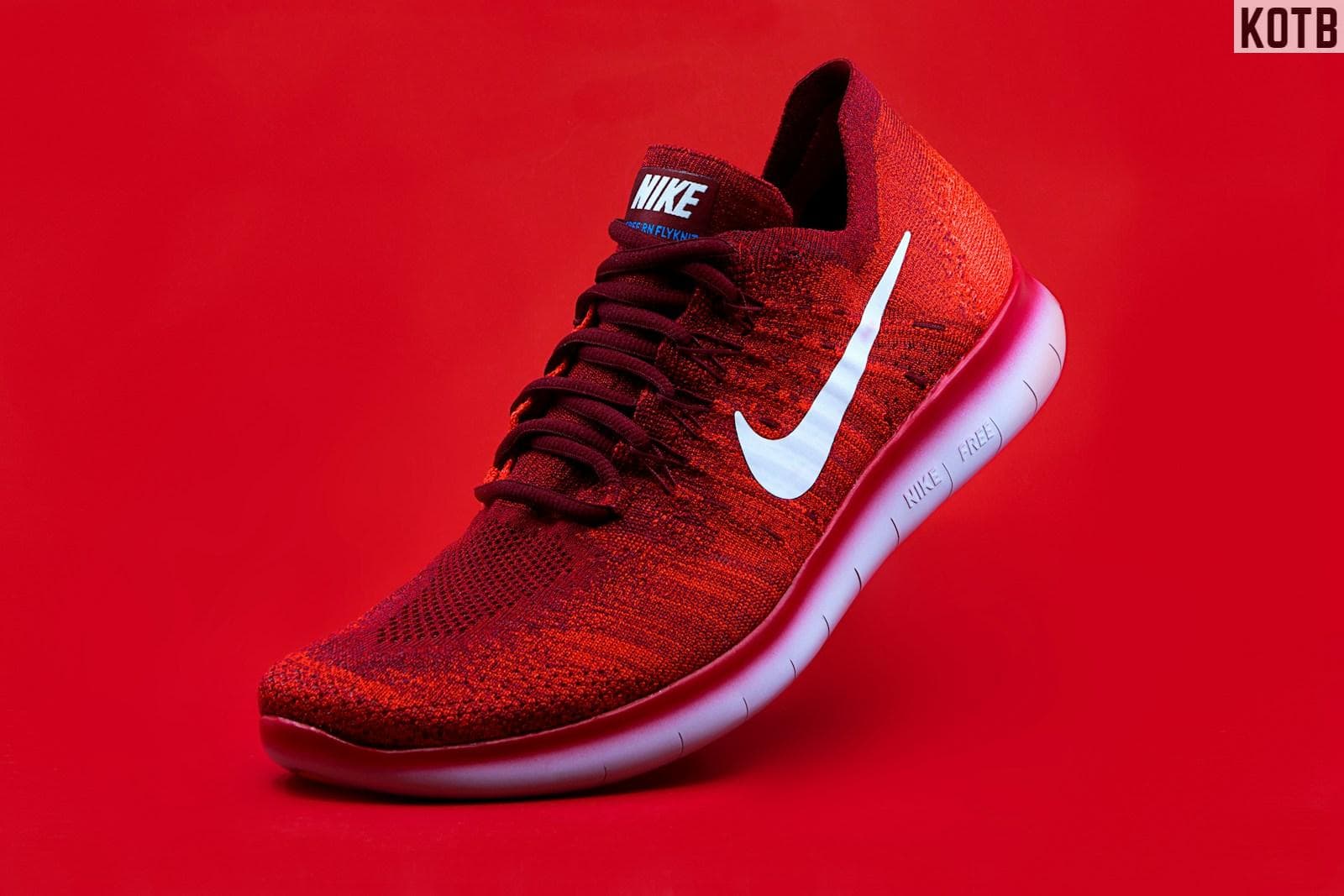 unpaired red Nike sneaker