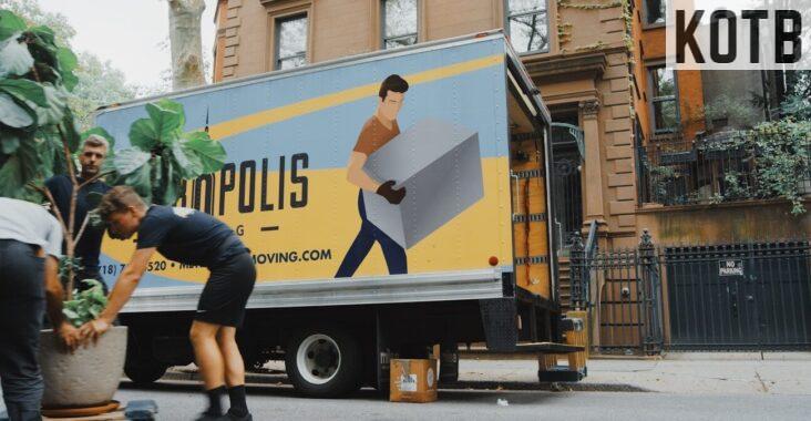 woman in blue shorts and black boots standing beside yellow and white truck during daytime